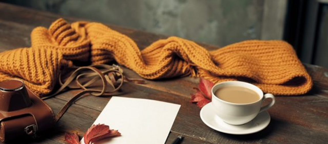 Opened craft paper envelope , autumn leaves and coffee on wooden table; Shutterstock ID 737031019; purchase_order: -; job: -; client: -; other: -